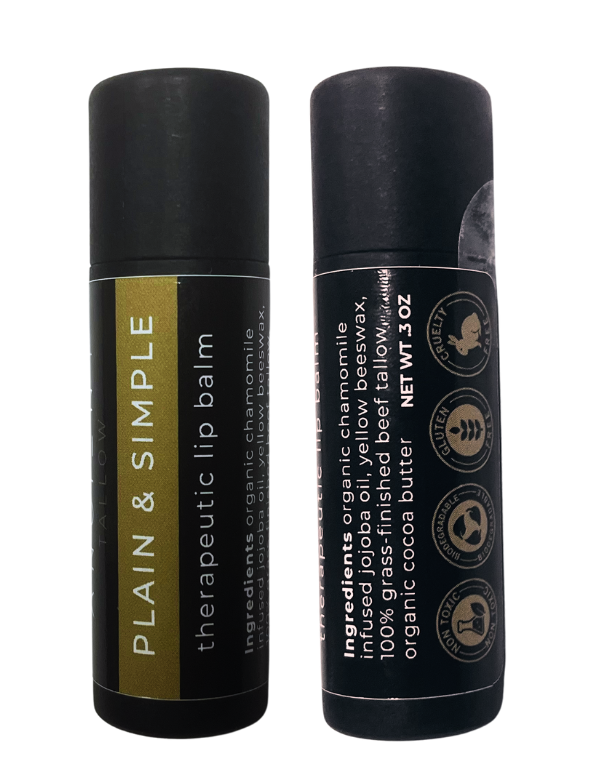 Two tubes of Ancient Tallow Therapeutic Lip Balm, one standing upright and the other lying down. The standing tube has a black and gold label, while the lying tube has a mostly black label with some text symbols.