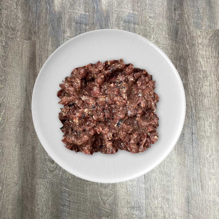 A bowl of BioComplete Natural Raw Mackerel Ground Purity, which appears to be ground mackerel flesh.