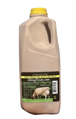 A bottle of Alday Farm Raw Cow Milk Chocolate with a yellow cap, against a plain background.