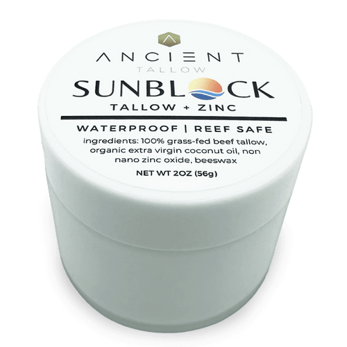 A container of Ancient Tallow and Zinc Sunblock with the label showing the product name and ingredients, emphasizing waterproof and reef safe features.
