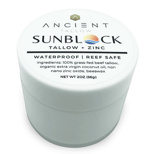 A container of Ancient Tallow and Zinc Sunblock with the label showing the product name and ingredients, emphasizing waterproof and reef safe features.