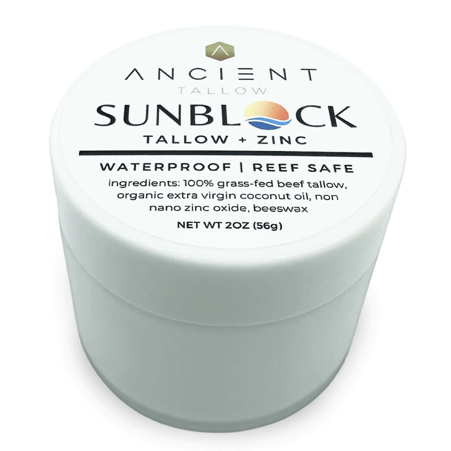 A container of Ancient Tallow and Zinc Sunblock with the label showing the product name and ingredients, emphasizing waterproof and reef safe features.