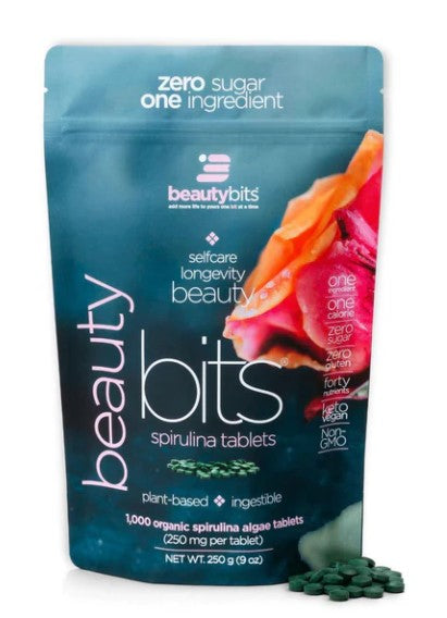 A package of BEAUTYbits Spirulina tablets with a visual emphasis on the product's natural and healthy attributes, including a zero sugar claim.