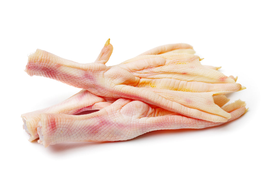 Two raw duck feet on a white background.