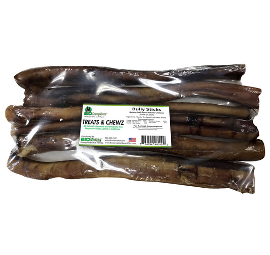 Packaged BioComplete Natural Baked Bully Sticks for dogs, visible through the clear plastic wrapping with a label showing the brand and product name.