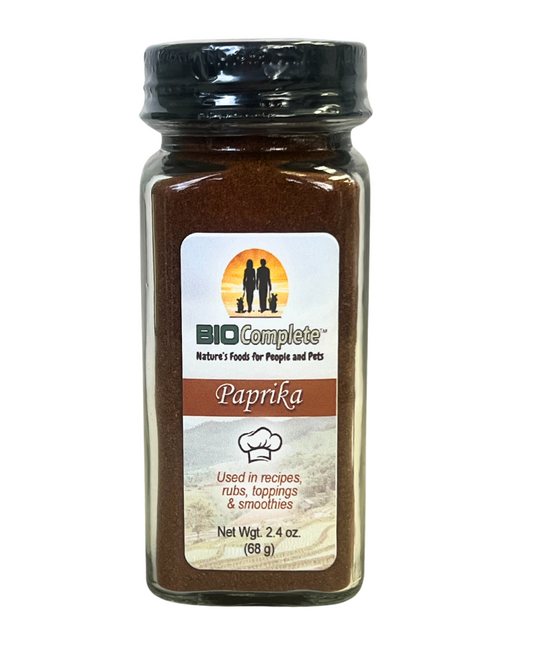 A bottle of BioComplete Paprika Powder Culinary. The label shows the BioComplete logo, a paprika pepper image, and text indicating the product is used in recipes ranging from soups, stews, and smoothies.