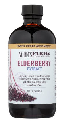 A bottle of Norm's Farm Elderberry Extract, with a label showing the product name and an image of elderberries. The bottle has a black cap and is labeled as a 'powerful immune system support' product.