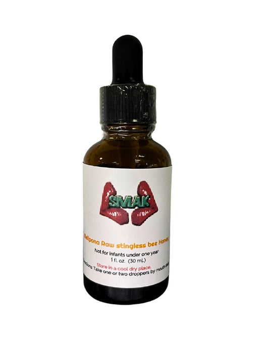 Bottle of SMiAK honey with a dropper on a white background