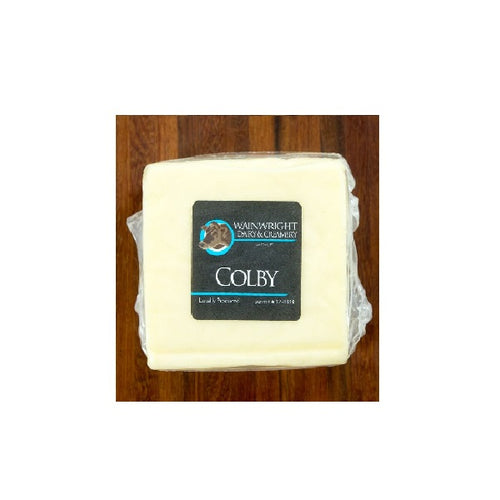 Packaged cheese labeled 'Wainwright' and 'Colby' on a wooden surface.