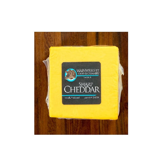 A block of sharp cheddar cheese with a label indicating it is Wainwright Farm Organic Yellow Cheddar Cow Cheese Sharp.